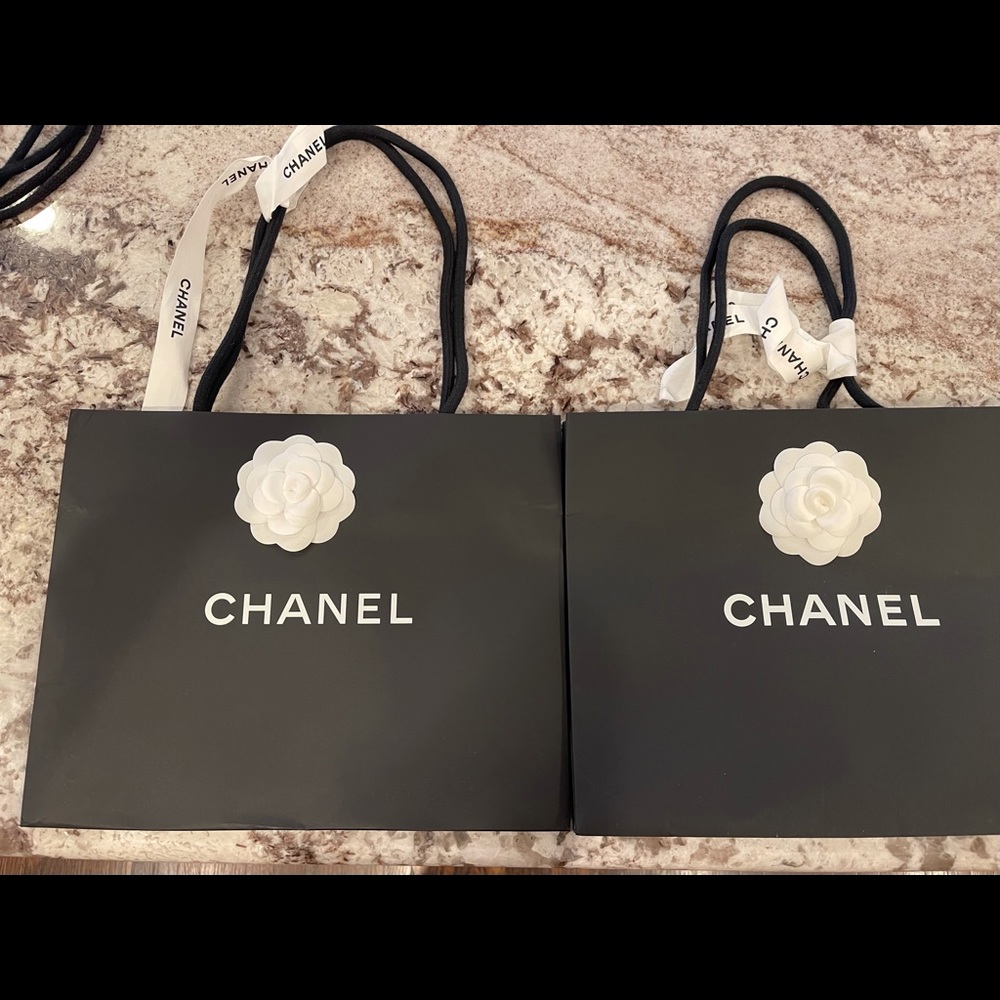 Two Chanel bags with ribbons and camellias